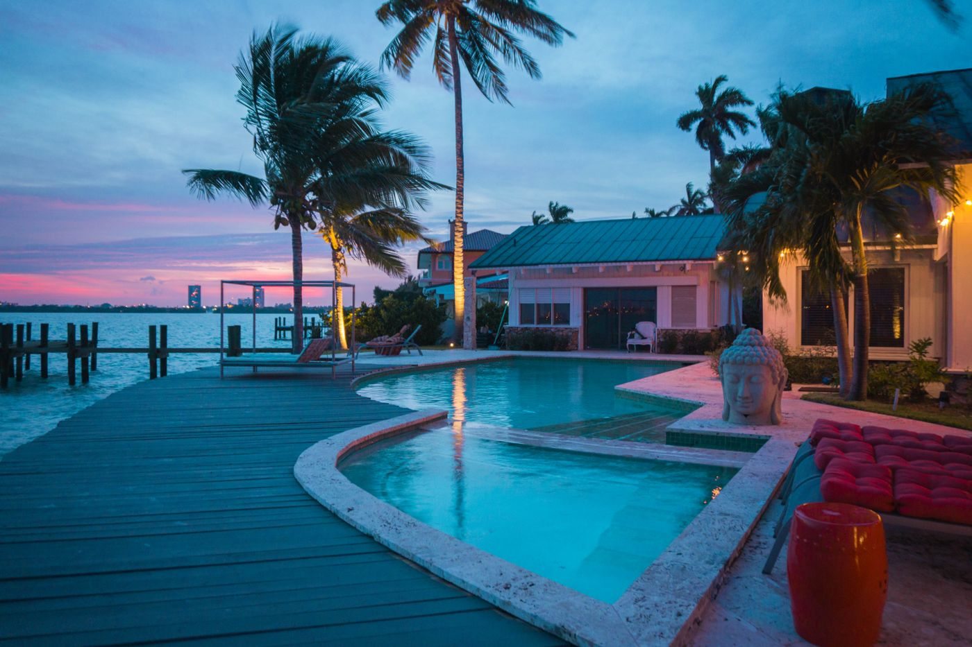 A bright, clean pool deck with palm trees at a South Florida home